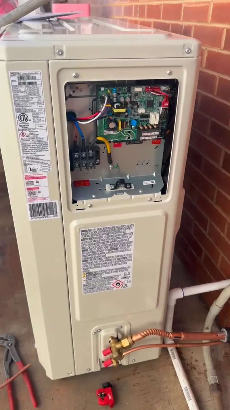 AC outdoor unit with service panel open in St. George, UT
