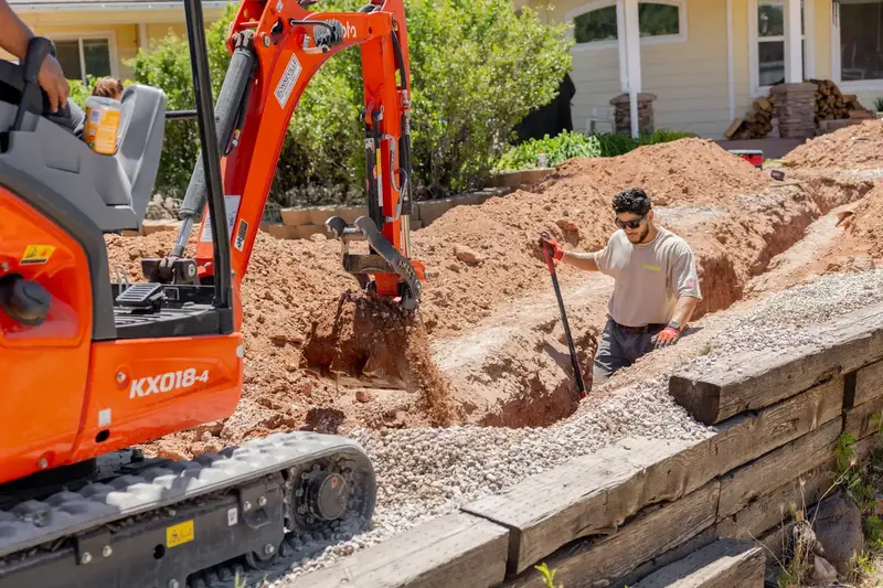 Element crew trenching beside a home in St. George, UT