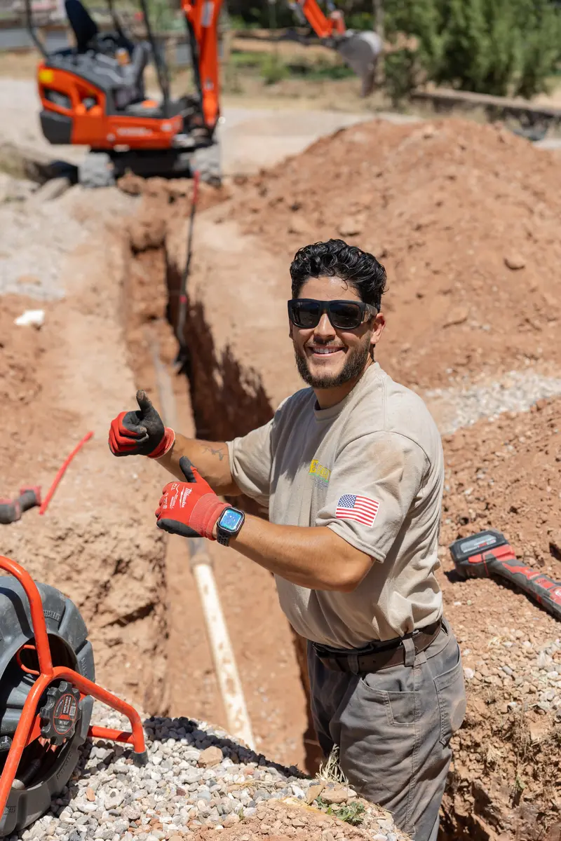 Element plumber at a sewer line trench in St. George, UT