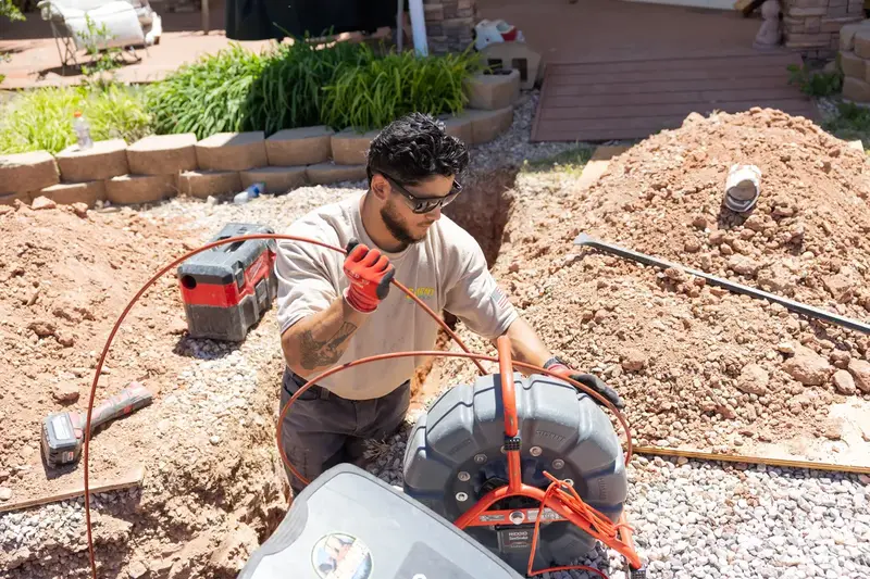 Element plumber guiding a sewer camera line in St. George, UT