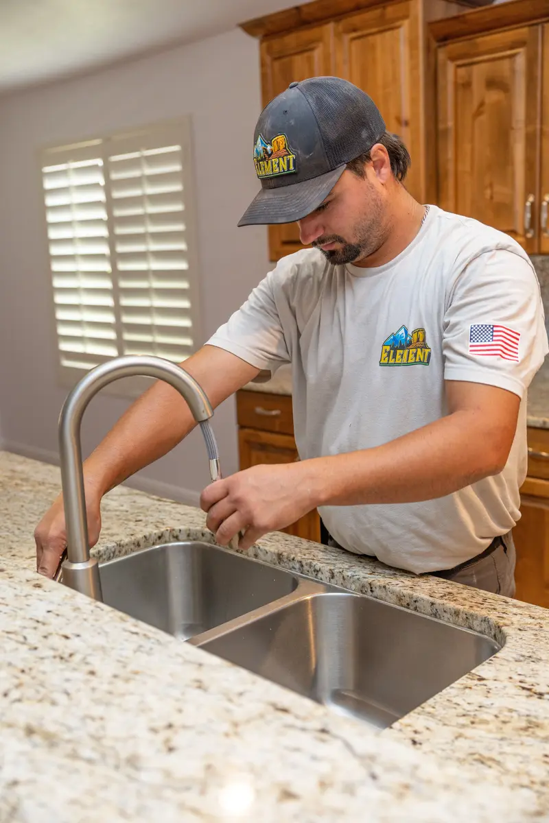 Element plumber installing a kitchen faucet in St. George, UT