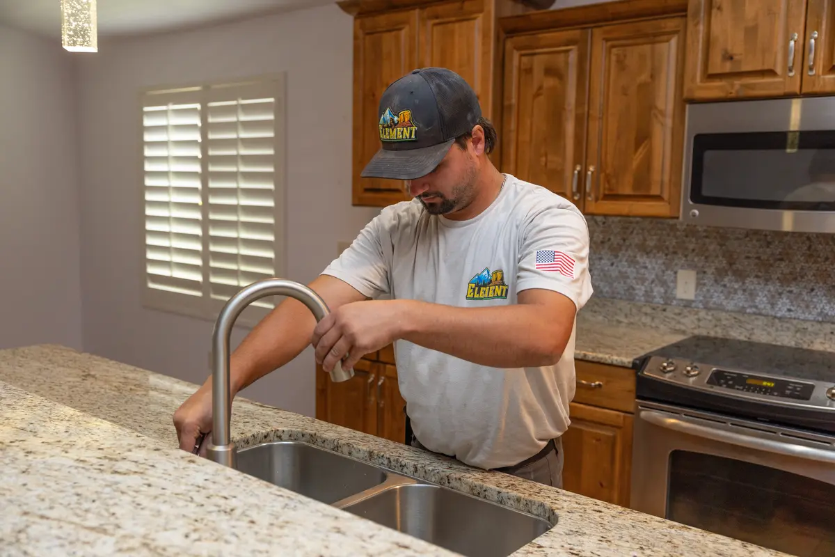 Element plumber testing a new kitchen faucet in St. George, UT
