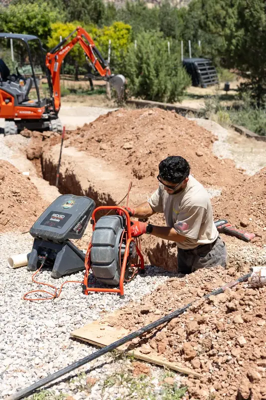 Element plumber with a camera reel in a trench in St. George, UT