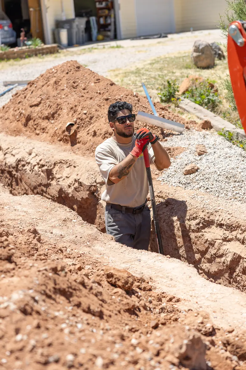 Element plumber working in a water line trench in St. George, UT